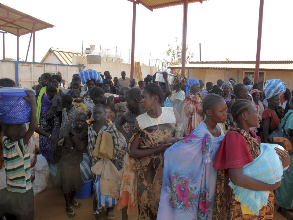 Displaced Sudanese civilians arrive at the United Nations Mission in the Republic of South Sudan compound on the outskirts of the capital Juba