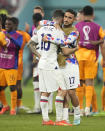 Christian Pulisic of the United States, left, is comforted by teammate Cristian Roldan at the end of the World Cup round of 16 soccer match between the Netherlands and the United States, at the Khalifa International Stadium in Doha, Qatar, Saturday, Dec. 3, 2022. (AP Photo/Ashley Landis)