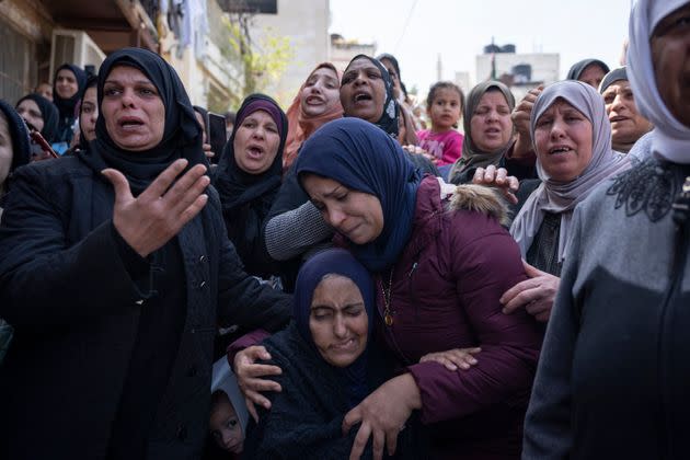 Palestinian Manal Abu Atiyeh, sitting center, is comforted by relatives during the funeral of her son Sanad Abu Atiyeh, 17, in the West Bank refugee camp of Jenin, Jenin, Thursday, March 31, 2022. Israeli forces raided a refugee camp in the occupied West Bank early Thursday, setting off a gun battle in which two Palestinians were killed and 15 were wounded, the Palestinian Health Ministry said. (AP Photo/Nasser Nasser) (Photo: via Associated Press)