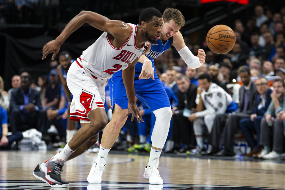 Dallas Mavericks forward Luka Doncic, right, reacts after being hit as Chicago Bulls forward Thaddeus Young (21) runs after the ball during the first half of an NBA basketball game, Monday, Jan. 6, 2020, in Dallas. (AP Photo/Sam Hodde)