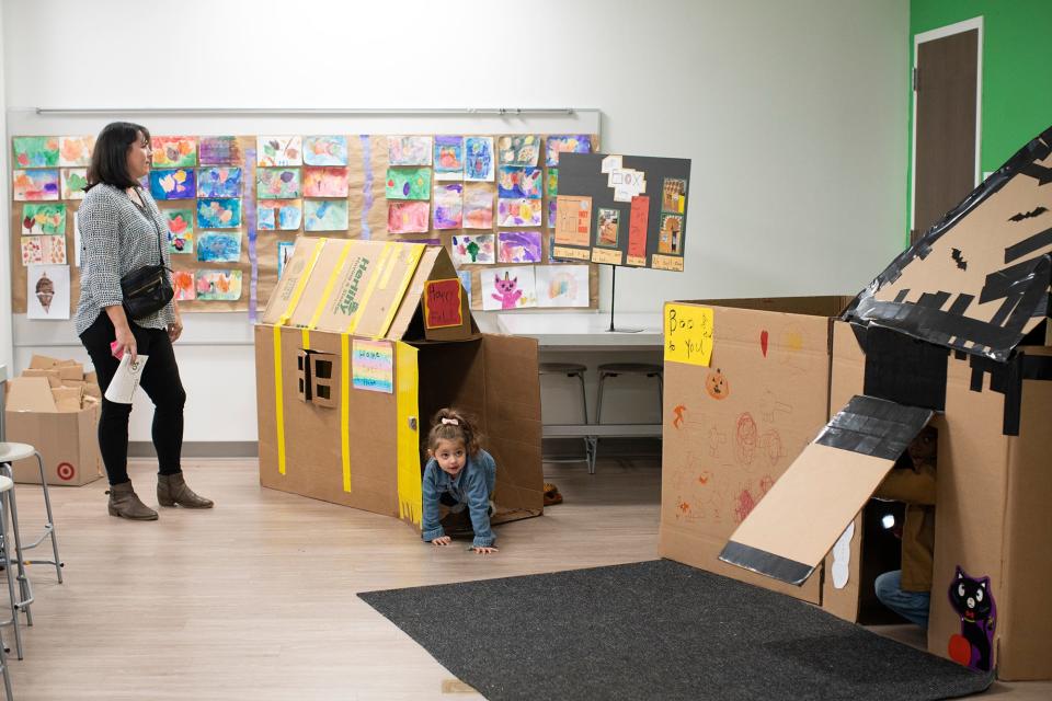 Livia Boulos, 3, plays in cardboard houses while her mother, Rachel, watches during Wickliffe Progressive Elementary School's open house to celebrate 50 years of the informal education program in Upper Arlington City Schools.