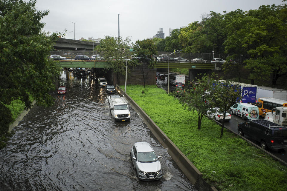 Traffic makes its way through flood waters along the Brooklyn Queens Expressway, Friday, Sept. 29, 2023, in New York. A potent rush-hour rainstorm has swamped the New York metropolitan area. The deluge Friday shut down swaths of the subway system, flooded some streets and highways, and cut off access to at least one terminal at LaGuardia Airport. (AP Photo/Robert Bumsted)