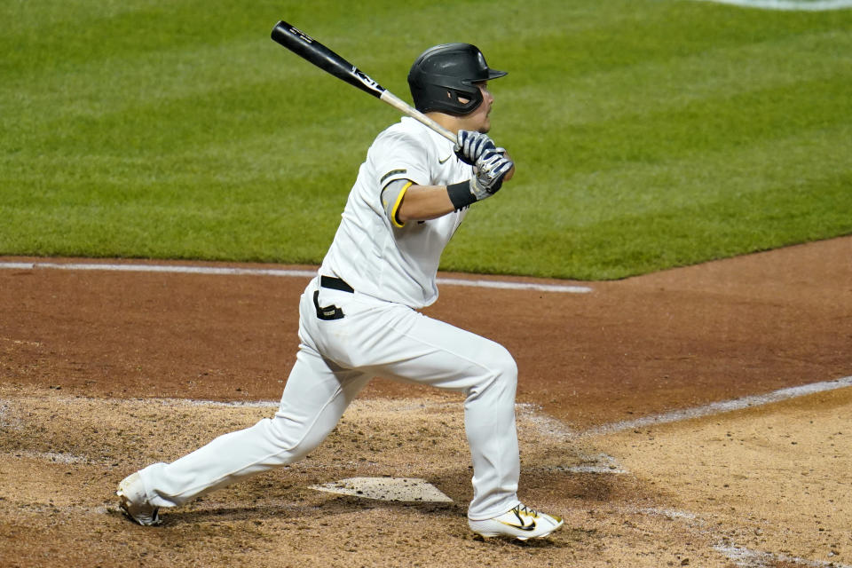 Pittsburgh Pirates' Yoshi Tsutsugo hits an infield single off Colorado Rockies relief pitcher Tyler Kinley, driving in the go-ahead run, during the eighth inning of a baseball game in Pittsburgh, Monday, May 23, 2022. (AP Photo/Gene J. Puskar)
