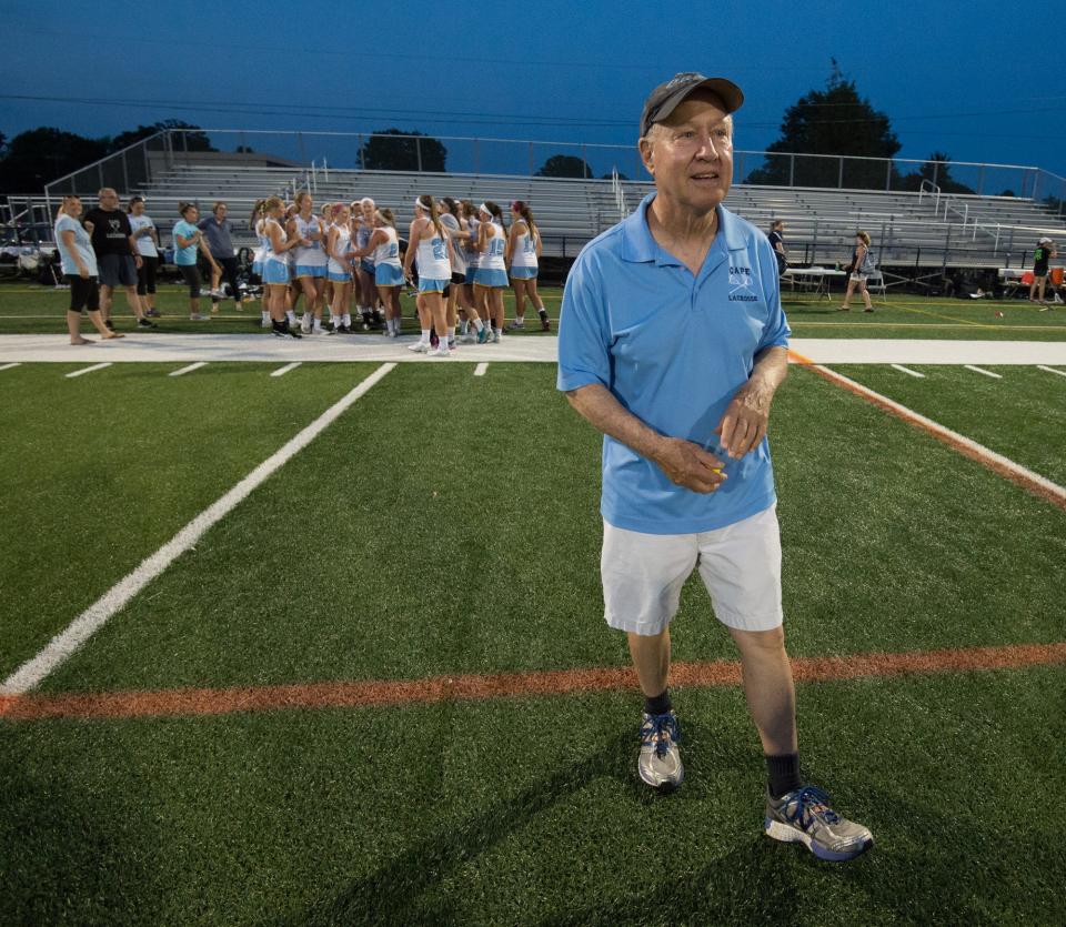 Cape Henlopen's girls lacrosse team head coach, PJ Kesmodel, on the field after winning the DIAA girls lacrosse championship game against Tower Hill at Wesley College in Dover.