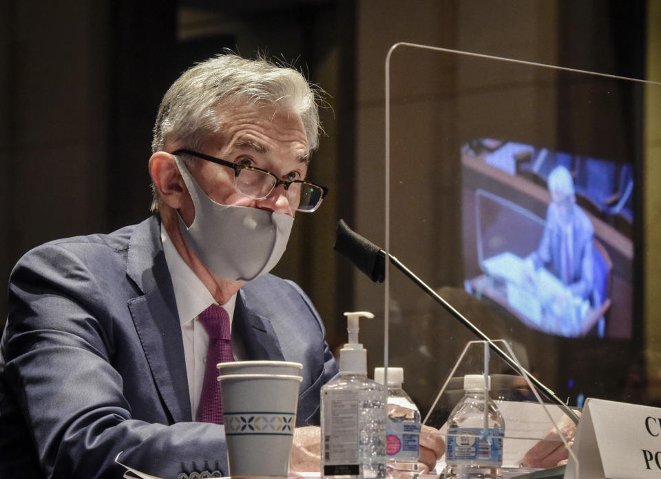 Federal Reserve Board Chairman Jerome Powell, reflected in the sneeze guard set up between himself and members of the House Committee on Financial Services, speaks during a hearing on oversight of the Treasury Department and Federal Reserve pandemic response, Tuesday, June 30, 2020 on Capitol Hill in Washington. (Bill O'Leary/The Washington Post via AP, Pool)