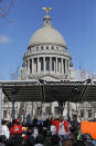 Several hundred people gather in front of the Mississippi Capitol in Jackson, on Friday, Jan. 24, 2020, to protest conditions in prisons where inmates have been killed in violent clashes in recent weeks. Mississippi's new governor says he and the interim corrections commissioner toured a troubled state prison to see conditions and to try to understand what led to an outburst of deadly violence in recent weeks. (AP Photo/Rogelio V. Solis)