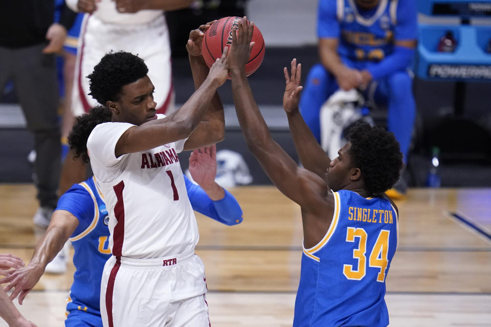 Alabama forward Herbert Jones (1) drives on UCLA guard David Singleton (34) in the first half of a Sweet 16 game in the NCAA men's college basketball tournament at Hinkle Fieldhouse in Indianapolis, Sunday, March 28, 2021. (AP Photo/Michael Conroy)