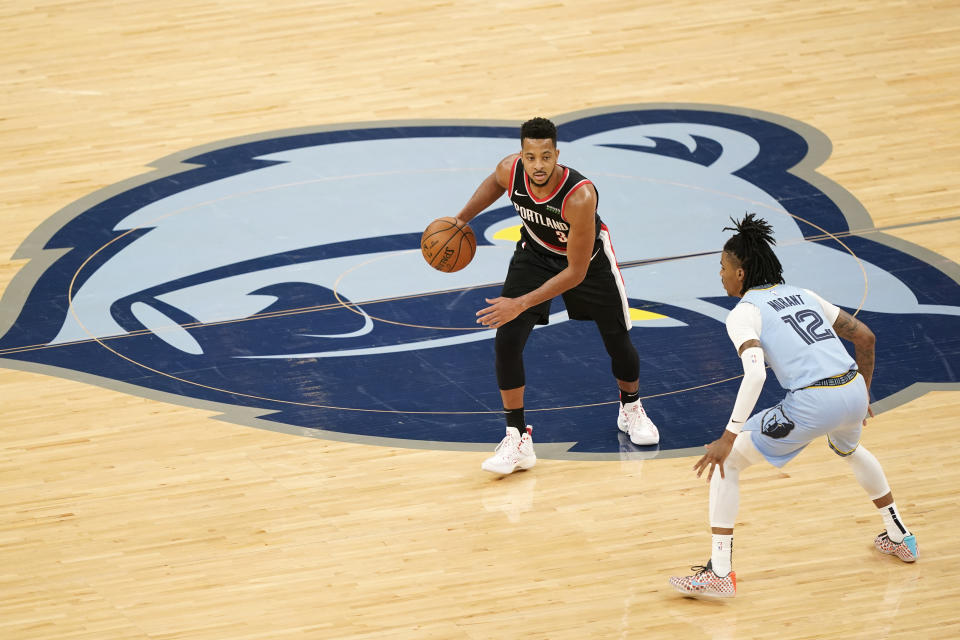 Portland Trail Blazers' CJ McCollum (3) is defended by Memphis Grizzlies' Ja Morant (12) in the second half of an NBA basketball game Wednesday, April 28, 2021, in Memphis, Tenn. (AP Photo/Mark Humphrey)