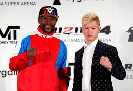 Undefeated boxer Floyd Mayweather Jr. of the U.S. poses for a photograph with his opponent Tenshin Nasukawa during a news conference to announce he is joining Japanese Mixed Martial Arts promotional company Rizin Fighting Federation, in Tokyo, Japan November 5, 2018. REUTERS/Issei Kato TPX IMAGES OF THE DAY