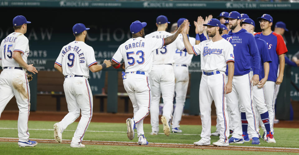 The Texas Rangers celebrate a 5-3 win over the Oakland Athletics after a baseball game, Wednesday, June 23, 2021, in Arlington, Texas. (AP Photo/Brandon Wade)