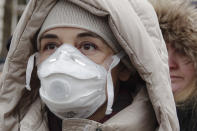Women wearing face masks take part in a protest against air pollution, in Sarajevo, Bosnia, Monday, Jan. 20, 2020. Dozens of people, some wearing face masks, gathered for a protest because of dangerously high levels of air pollution in the past weeks in the Bosnian capital after measurements in the past weeks have shown that levels of damaging airborne particles have exceeded European Union's safety norms by several times.(AP Photo/Eldar Emric)