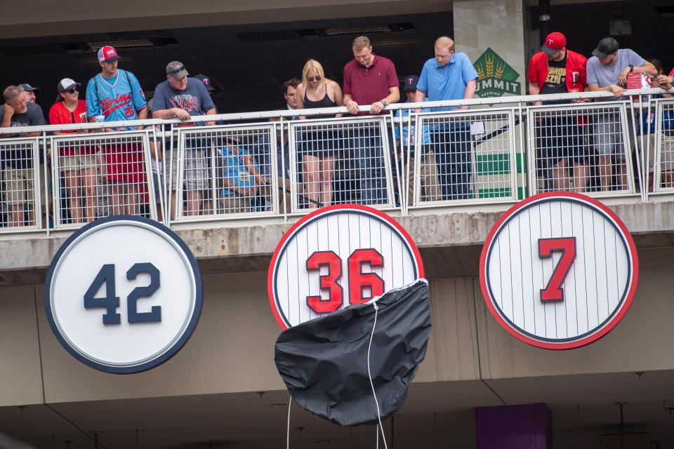 Fans watch as Minnesota Twins former pitcher Jim Kaat's retired number, 36, is unveiled during a ceremony before their game against he Chicago White Sox, Saturday, July 16, 2022, in Minneapolis. Kaat will be inducted into the Baseball Hall of Fame later this month. (AP Photo/Craig Lassig)