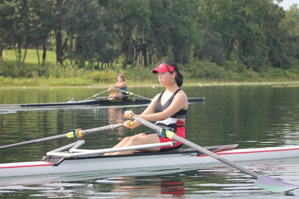 Sarah Herr of Leon (background) and Tracy Qu of Chiles work on their endurance at Lake Hall.