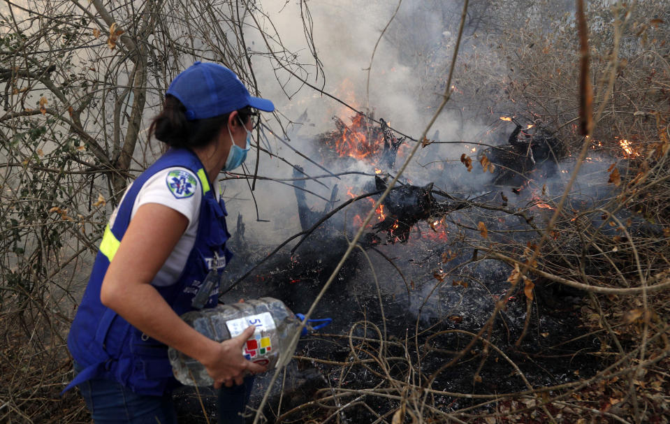 A volunteer works to put out a fire in Aguas Calientes on the outskirts of Robore, Bolivia, Aug. 24, 2019. (Photo: Juan Karita/AP)