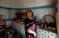 Saliha Mohamedi, 36, looks out from the kitchen of her troglodyte house on the outskirts of Matmata, Tunisia, February 4, 2018. REUTERS/Zohra Bensemra