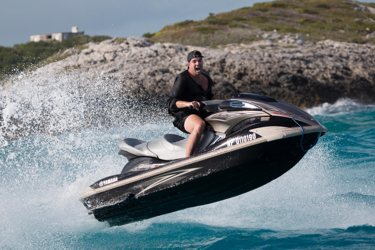 Fyre Festival organizer Billy McFarland on a jet ski in <em>Fyre</em>. (Photo: Netflix)