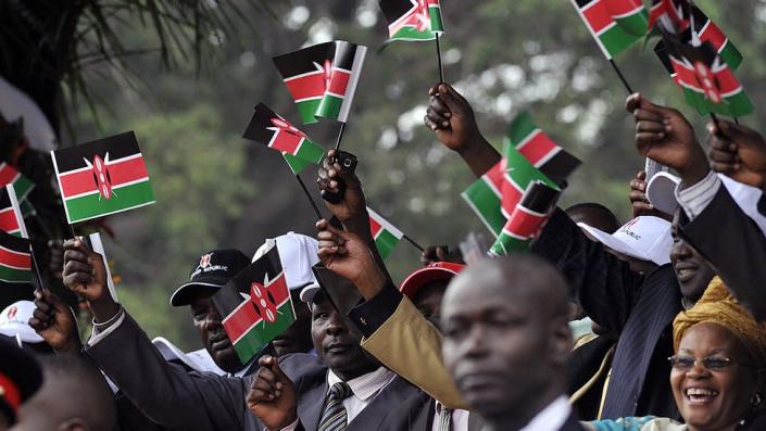 People waving Kenyan flags