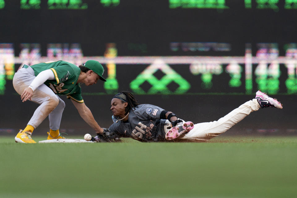 Washington Nationals' CJ Abrams, right, steals second base during the first inning of a baseball game against the Oakland Athletics, Saturday, Aug. 12, 2023, in Washington. (AP Photo/Stephanie Scarbrough)