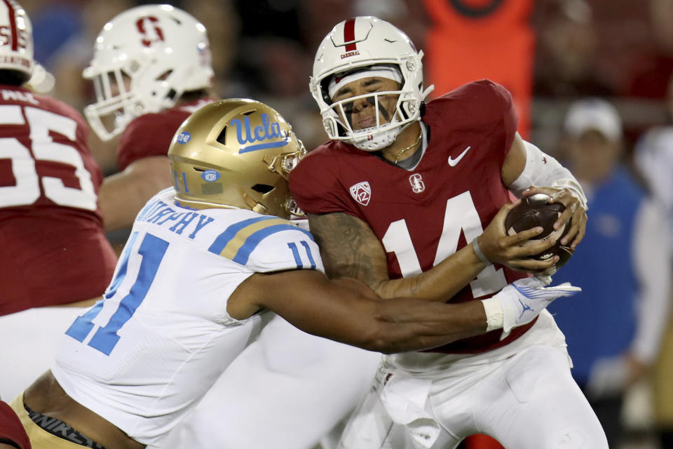 UCLA defensive lineman Gabriel Murphy (11) sacks Stanford quarterback Ashton Daniels (14) during an NCAA college football game, Saturday, Oct. 21, 2023, in Stanford, Calif. (AP Photo/Scot Tucker)