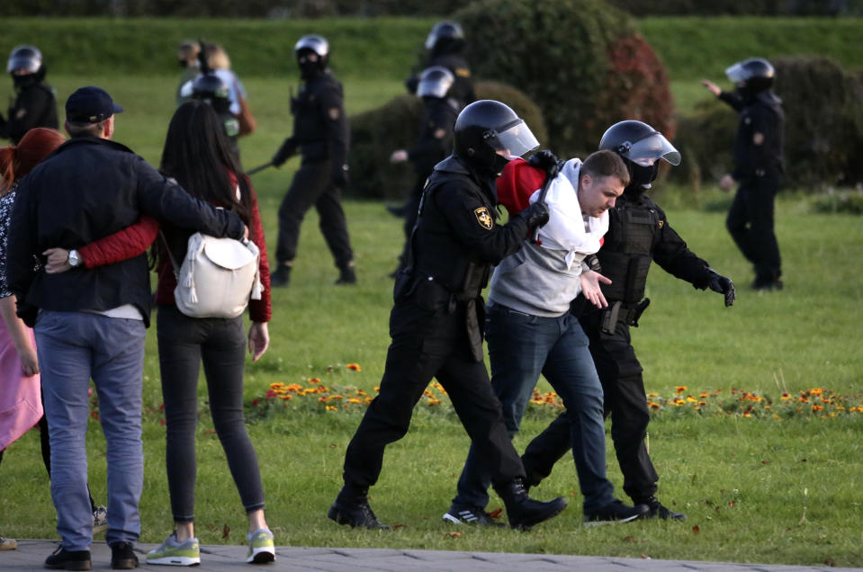 Riot police detain a protester during an opposition rally to protest the presidential inauguration in Minsk, Belarus, Wednesday, Sept. 23, 2020. Belarus President Alexander Lukashenko has been sworn in to his sixth term in office at an inaugural ceremony that was not announced in advance amid weeks of huge protests saying the authoritarian leader's reelection was rigged. Hundreds took to the streets in several cities in the evening to protest the inauguration. (AP Photo/TUT.by)