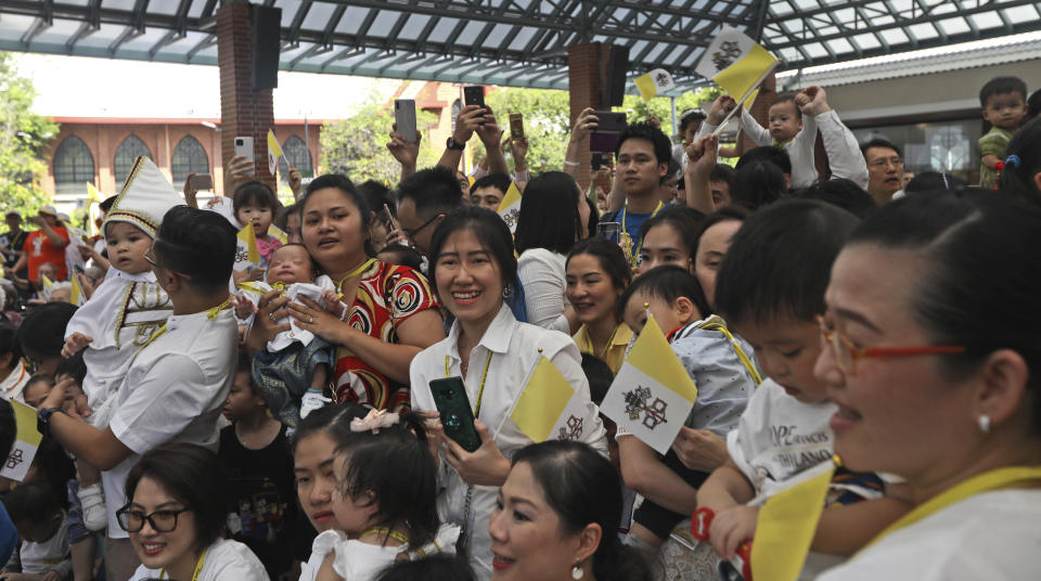 People look towards Pope Francis as he arrives at Saint Louis Hospital in Bangkok, Thailand, Thursday, Nov. 21, 2019. Pope Francis called for migrants to be welcomed and for women and children to be protected from exploitation, abuse and enslavement as he began a busy two days of activities in Thailand on Thursday. (AP Photo/Manish Swarup)