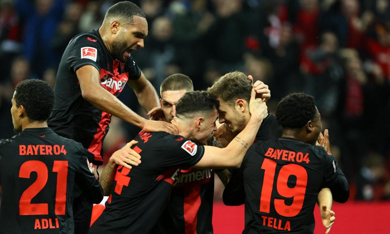 <span>Bayer Leverkusen celebrate Josip Stanisic’s opening goal against Bayern Munich.</span><span>Photograph: Wolfgang Rattay/Reuters</span>