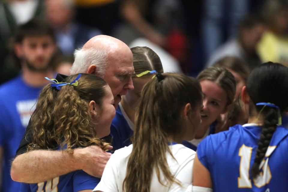 Muncie Burris volleyball head coach Jim Craig huddles his team after its 3-0 (25-23, 25-17, 25-20) victory over Pioneer at Frankfort High School on Saturday, Oct. 28, 2023.
