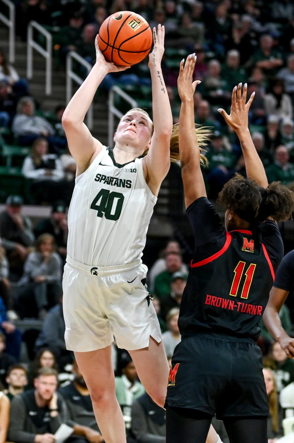 Michigan State's Julia Ayrault, left, shoots as Maryland's Jakia Brown-Turner defends during the third quarter on Tuesday, Jan. 9, 2024, at the Breslin Center in East Lansing.