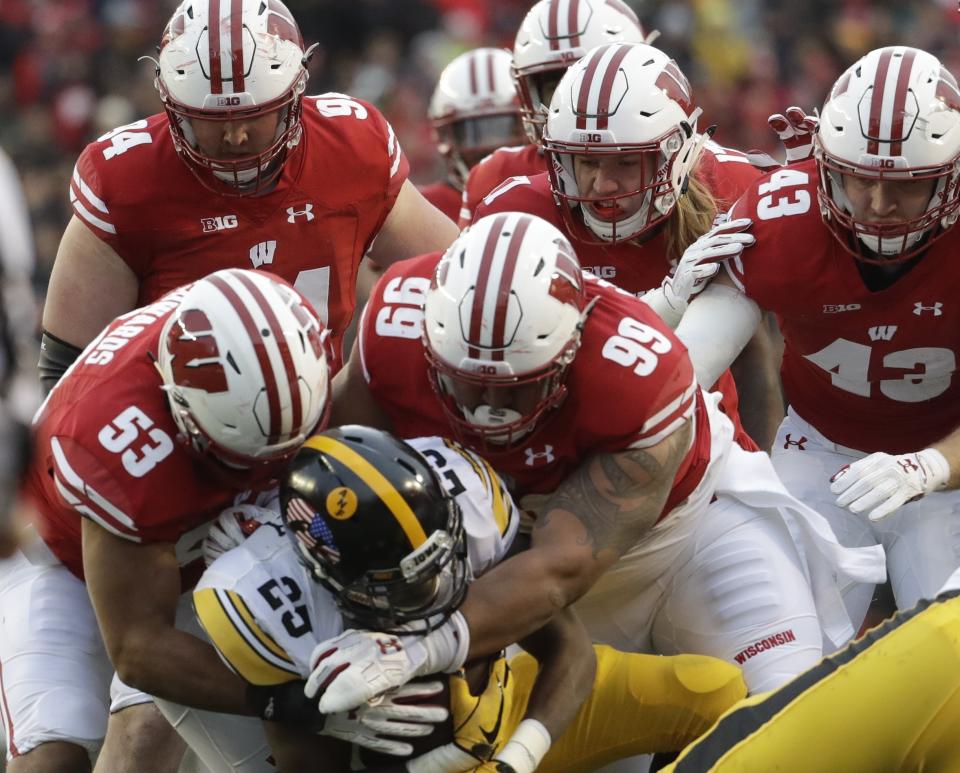 Iowa’s Akrum Wadley is stopped during the first half of an NCAA college football game against Wisconsin Saturday, Nov. 11, 2017, in Madison, Wis. (AP Photo/Morry Gash)