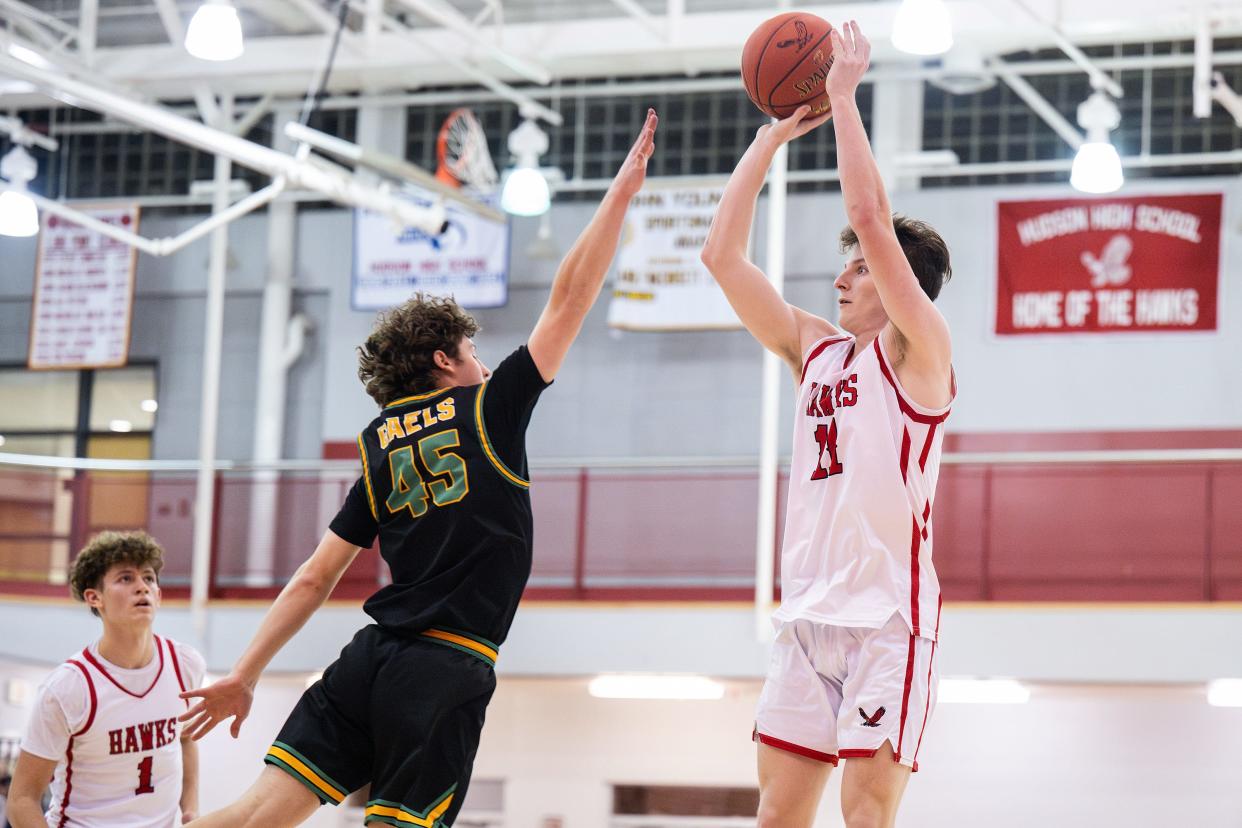 Hudson's Jackson O'Brien shoots as Clinton's Cam Grady defends on Friday January 12, 2024.