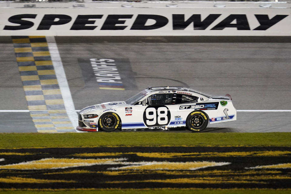 Chase Briscoe (98) crosses the finish line to win a NASCAR Xfinity Series auto race at Kansas Speedway in Kansas City, Kan., Saturday, Oct. 17, 2020. (AP Photo/Orlin Wagner)