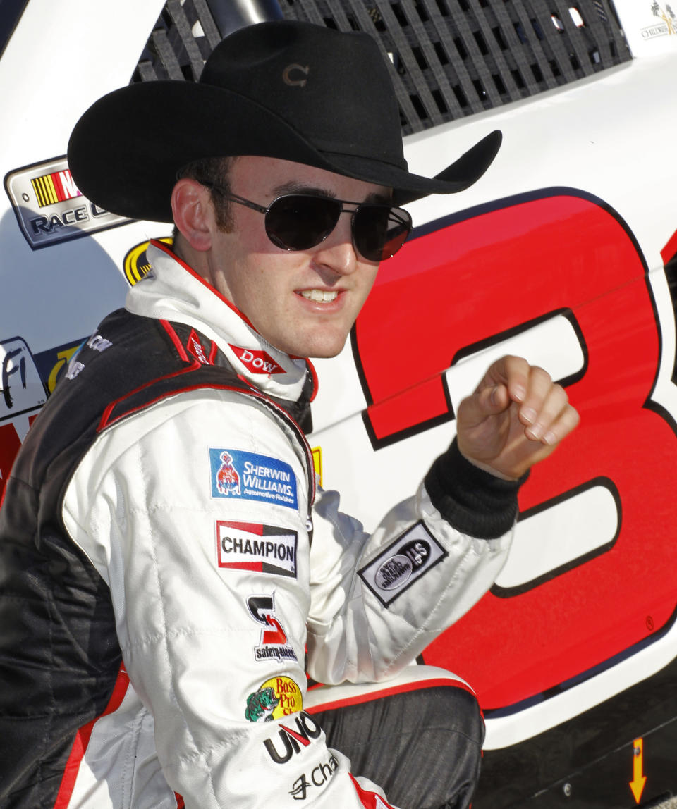 Daytona 500 NASCAR Sprint Cup Series auto race pole winner Austin Dillon poses by his car after his qualifying run at Daytona International Speedway in Daytona Beach, Fla., Sunday, Feb. 16, 2014. (AP Photo/Terry Renna)