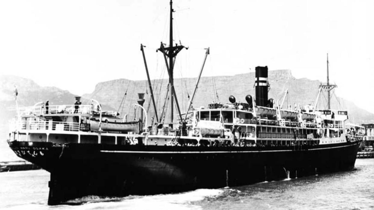  A black and white photo of the SS Montevideo Maru in the water.   