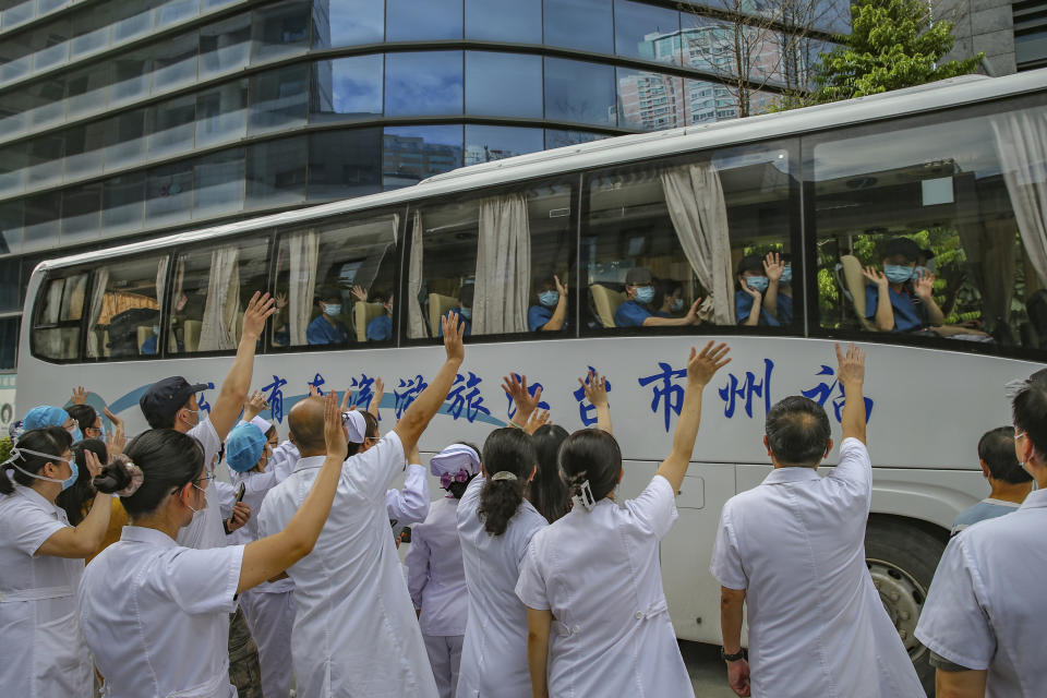 Medical workers send off their colleagues leaving to help with an outbreak of COVID-19 in Putian from a provincial hospital in Fuzhou in southeast China's Fujian province Sunday, Sept. 12, 2021. Putian, a city in southern China that is trying to contain a coronavirus outbreak told the public Sunday not to leave, suspended bus and train service and closed cinemas, bars and other facilities. (Chinatopix via AP)