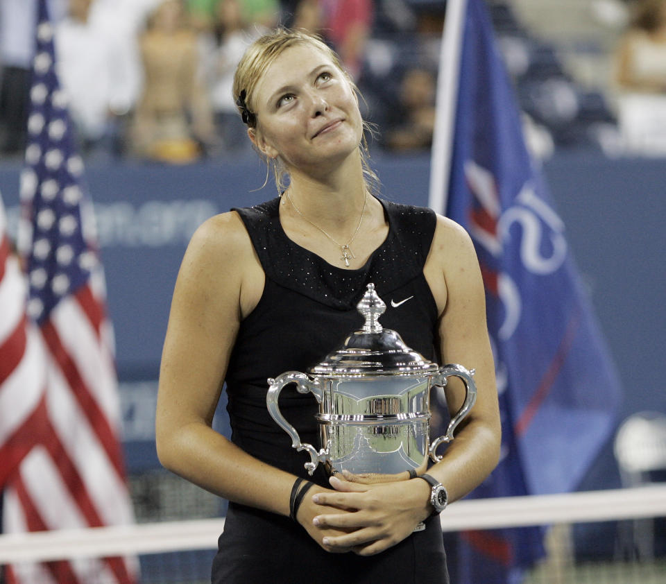 FILE - In this Sept. 9, 2006, file photo, Maria Sharapova looks up to the crowd after winning the women's singles championship over Justin Henin-Hardenne of Belgium at the U.S. Open tennis tournament in New York. Sharapova is retiring from professional tennis at the age of 32 after five Grand Slam titles and time ranked No. 1. She has been dealing with shoulder problems for years. In an essay written for Vanity Fair and Vogue about her decision to walk away from the sport, posted online Wednesday, Feb. 26, 2020, Sharapova asks: “How do you leave behind the only life you’ve ever known?” (AP Photo/Elise Amendola, File)