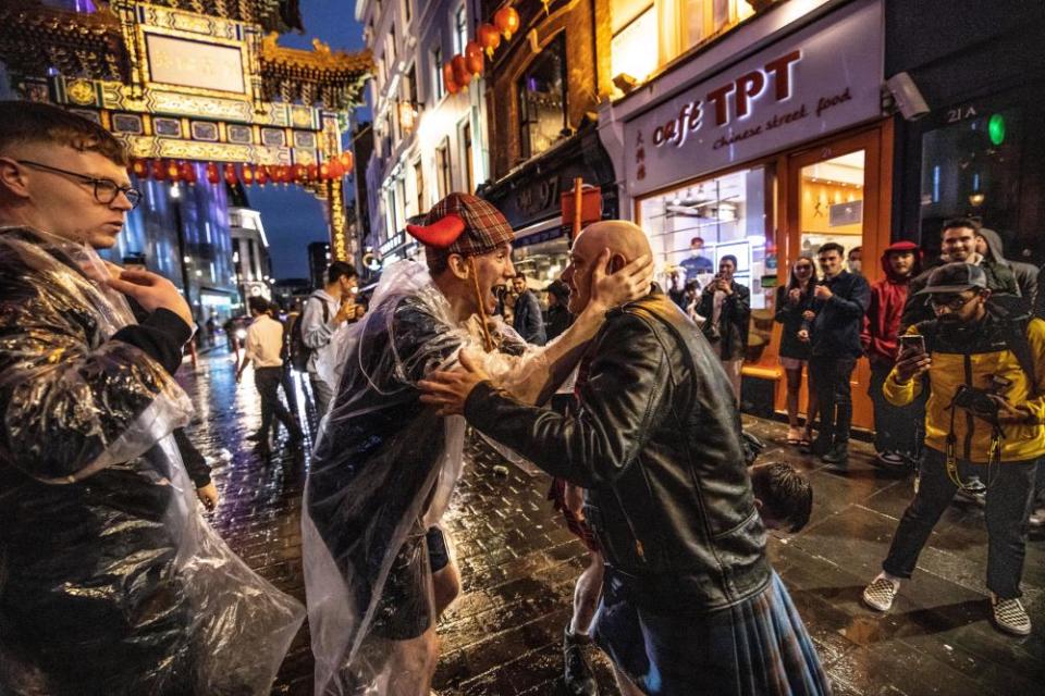 Scottish fans celebrate in the Leicester Square area after drawing 0-0 with England