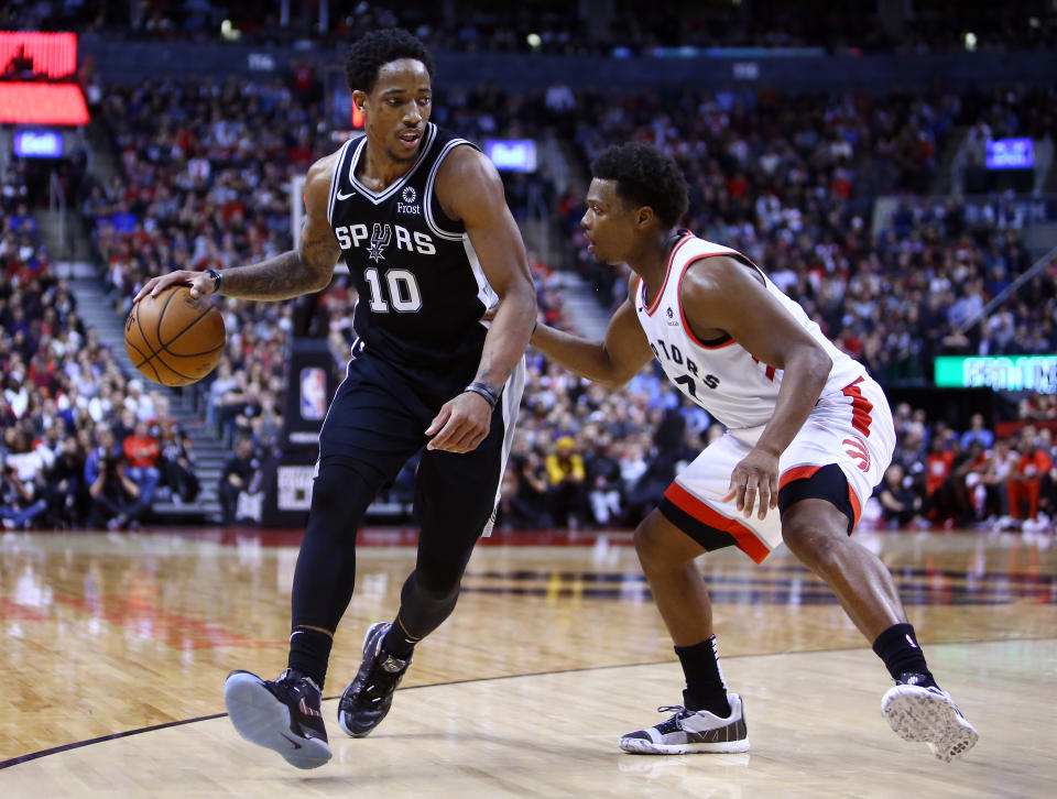 DeMar DeRozan dribbles against former teammate Kyle Lowry during the second half Friday night. (AP)