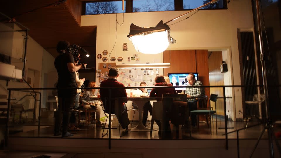 From left, Daniel Roher, Odessa Rae, Christo Grozev, Alexey Navalny and George Alburov gather around a table the day of the phone call. - Niki Waltl