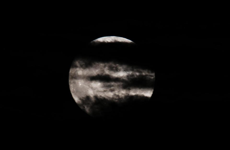 A supermoon appears in the clouds over West Lake in Hangzhou, Zhejiang province, China, on the evening of August 19, 2024. / Copyright: CFOTO/Future Publishing via Getty Images