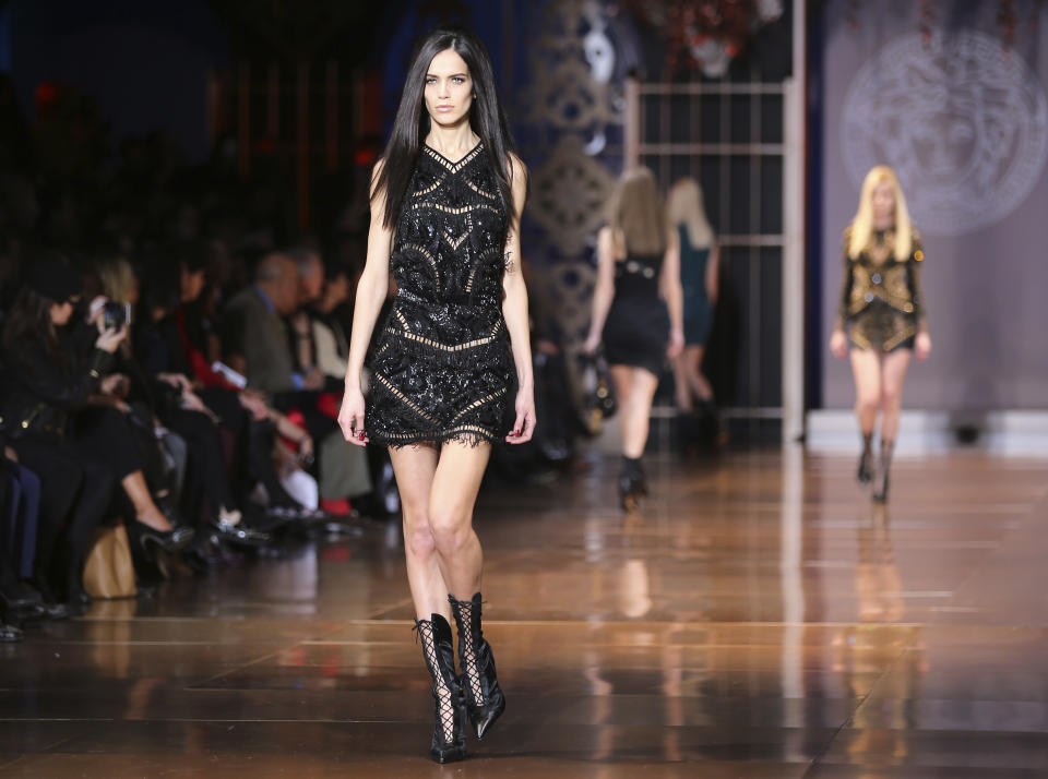 Models wear creations for Versace women's Fall-Winter 2014-15 collection, part of the Milan Fashion Week, unveiled in Milan, Italy, Friday, Feb. 21, 2014. (AP Photo/Antonio Calanni)