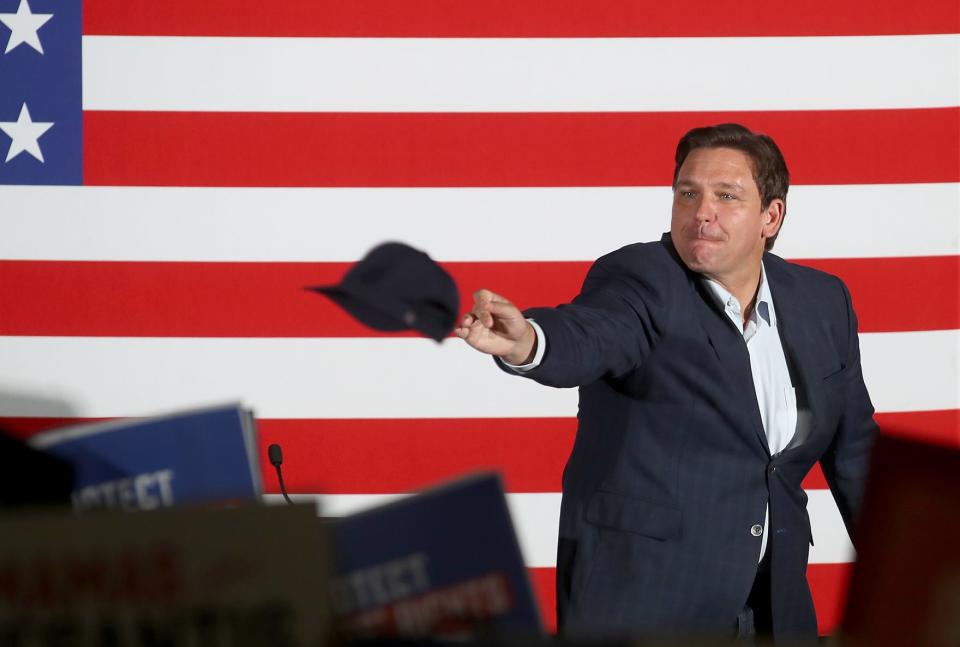 Florida Gov. Ron DeSantis throws hats out to a crowd of 500 to 1,000 supporters at the Sahib Shriner Event Center on Sunday as part of his Education Agenda Tour across the state. MATT HOUSTON/HERALD-TRIBUNE