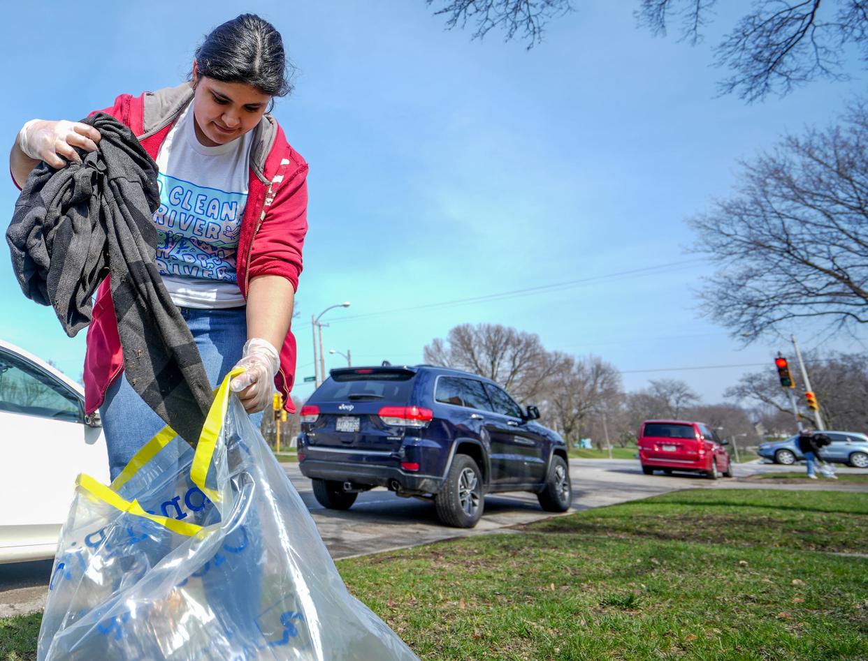 Kimberlyn Lopez, 19, picks up a jacket during the 27th Milwaukee Riverkeeper annual Spring Cleanup Saturday, April 23, 2022, at along South 16th Street in Milwaukee. "I don't like how people normalize throwing trash out of their window when they are driving," she said. "Over time, it ruins and destroys the world that we live in."