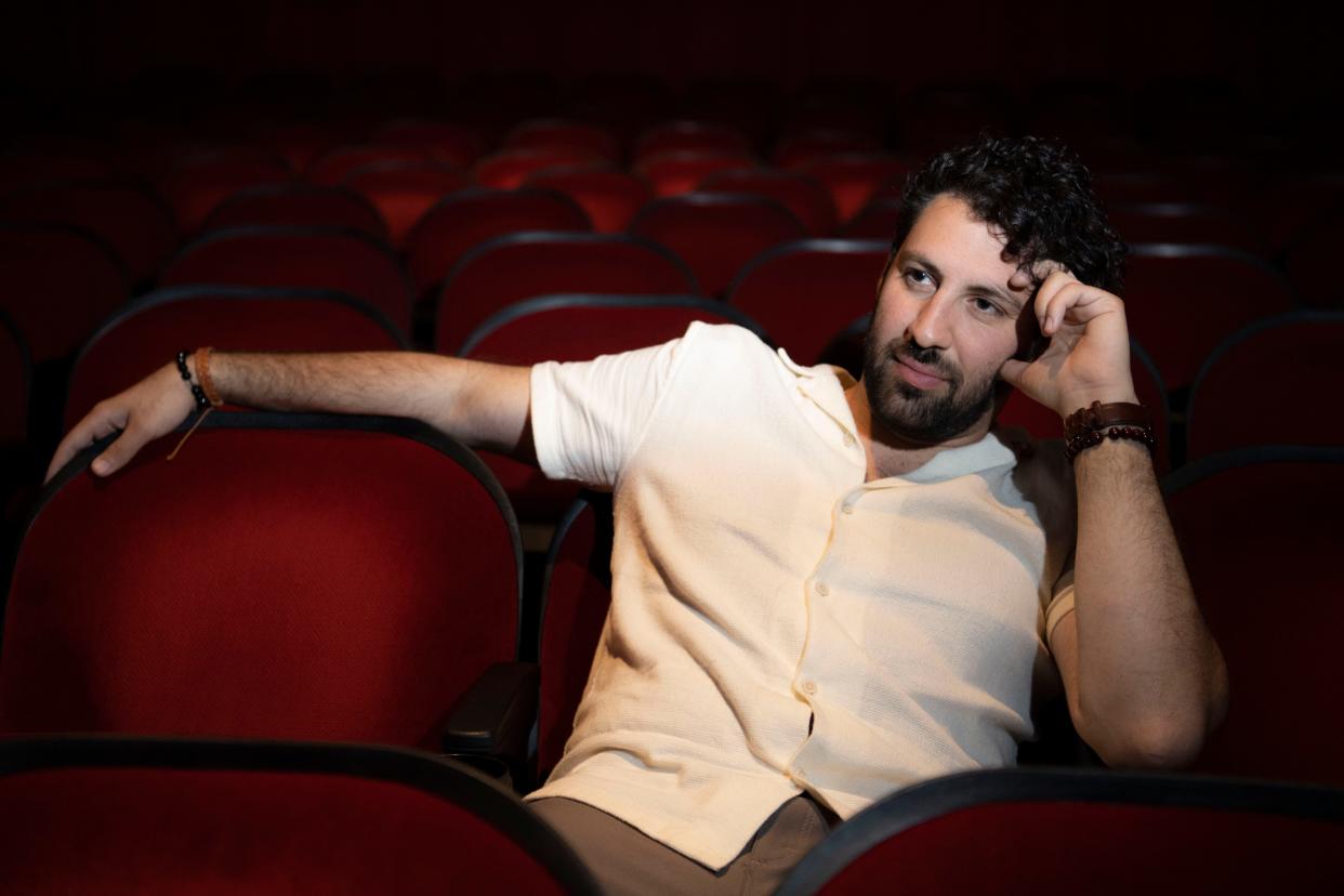 Ali Alsaleh, actor, sits inside the theater at Belcourt Theatre in Nashville , Tenn., Thursday, June 30, 2022. Alsaleh and his family were political refugees who fled Iraq in 2000 and moved to Nashville.