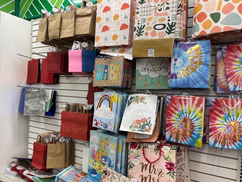 A display of different-size gift bags with various colorful designs.
