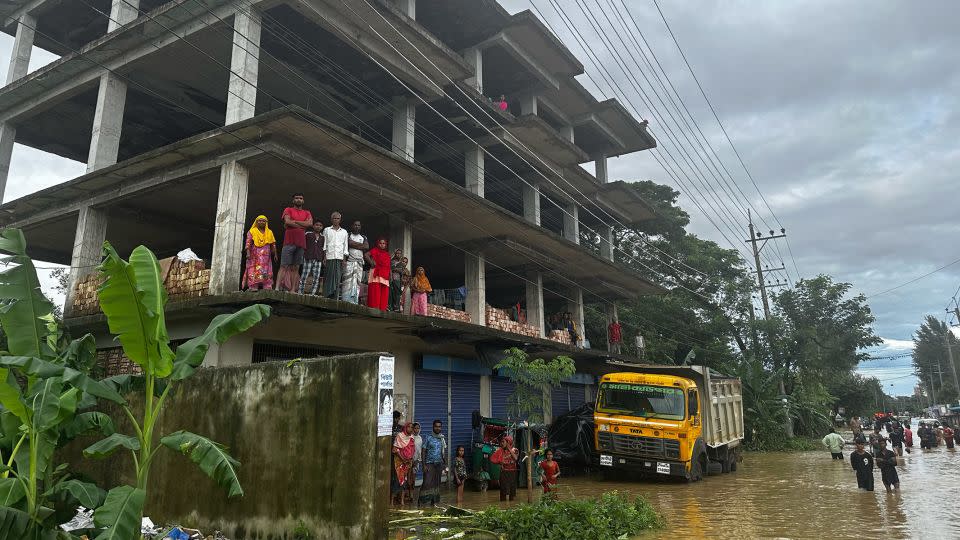 People in Feni, Bangladesh are seeking shelter from flooding in buildings throughout the city. - CNN/Rebecca Wright