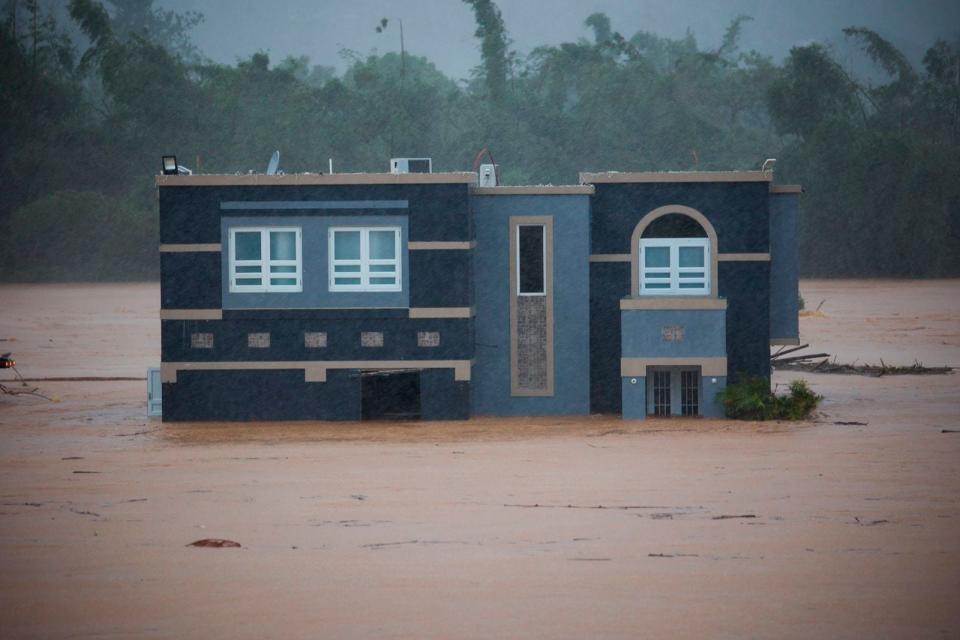 A house is pictured Sunday as floods caused by Hurricane Fiona in Cayey, Puerto Rico.