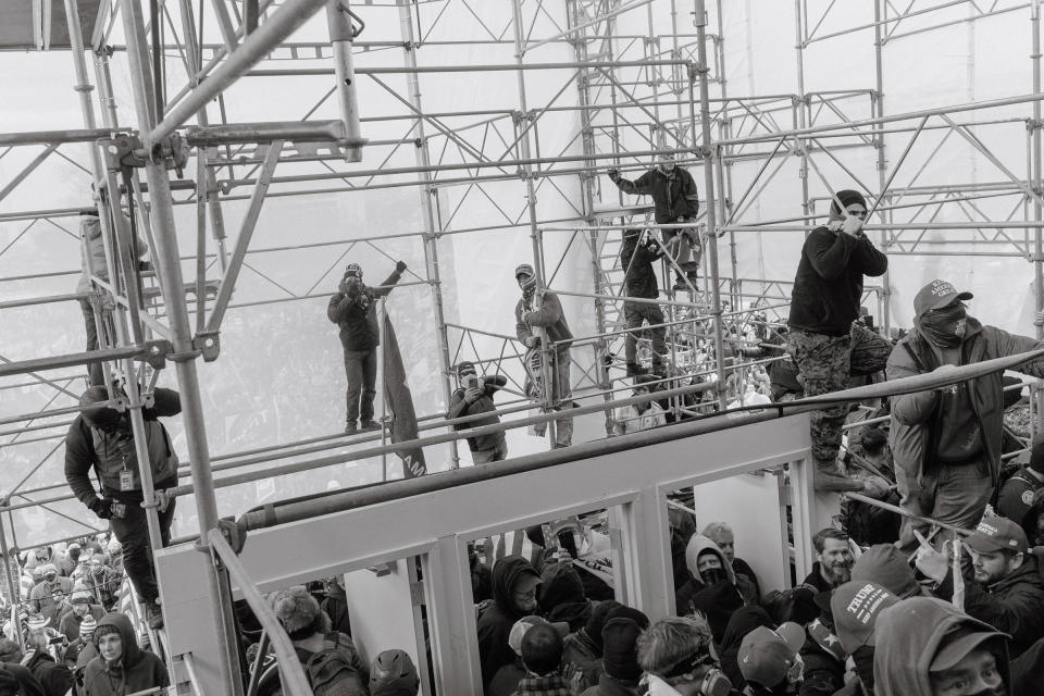 Pro-Trump rioters climb the scaffolding outside of the Capitol.<span class="copyright">Christopher Lee for TIME</span>