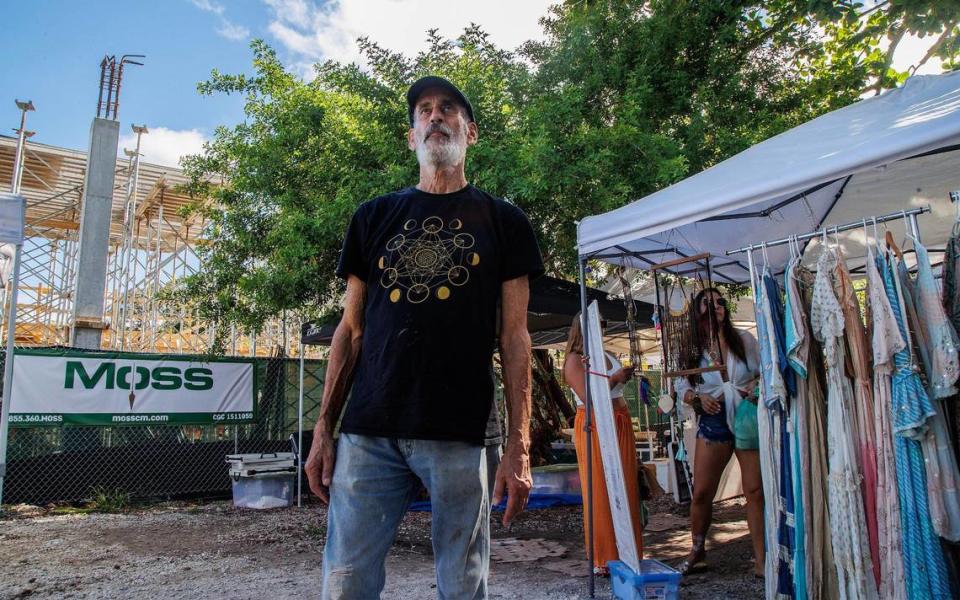 Stan Glaser, the manager of the Coconut Grove Organic Market and owner of Glaser Organic Farms, stands in front of the Elemi construction site that replaced two rows of market stalls and a parking area for the market. Saturday, August 12, 2023.