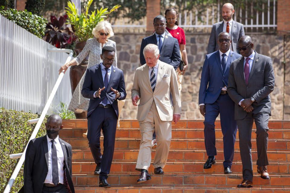 Britain's Prince Charles, center, and Camilla, Duchess of Cornwall, above-left, arrive to visit the Kigali Genocide Memorial in the capital Kigali, Rwanda Wednesday, June 22, 2022. Prince Charles has become the first British royal to visit Rwanda, representing Queen Elizabeth II as the ceremonial head of the Commonwealth at a summit where both the 54-nation bloc and the monarchy face uncertainty. (AP Photo)
