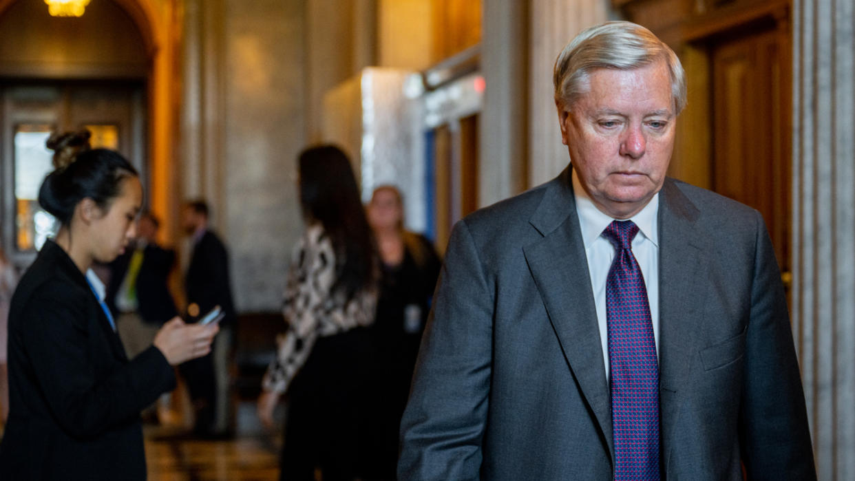 Sen. Lindsey Graham walks to a weekly Republican luncheon at the U.S. Capitol.